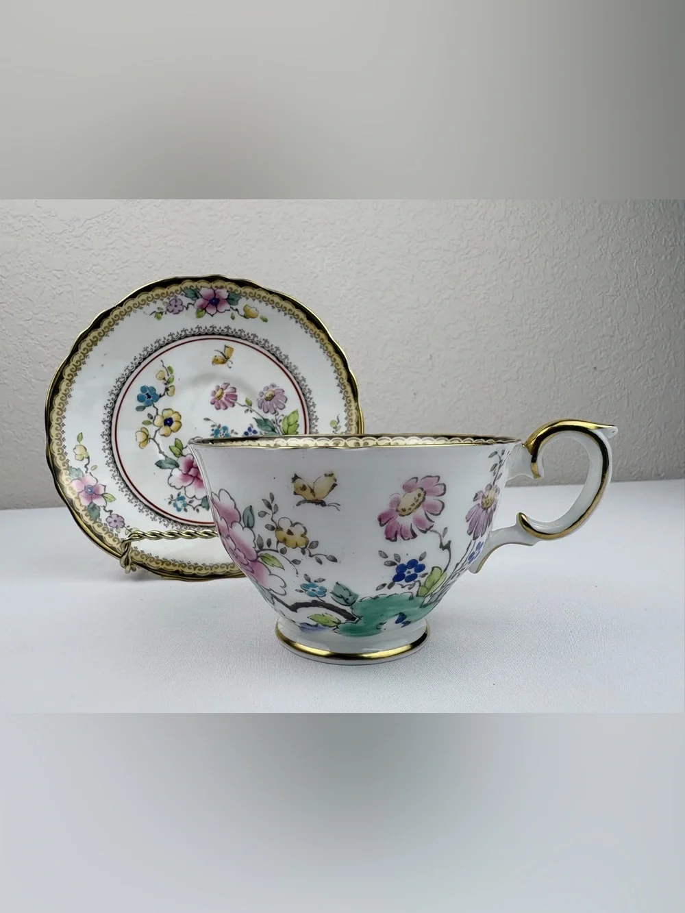 Vintage Crown Staffordshire Hand-Painted Floral and Butterfly Teacup and Saucer.